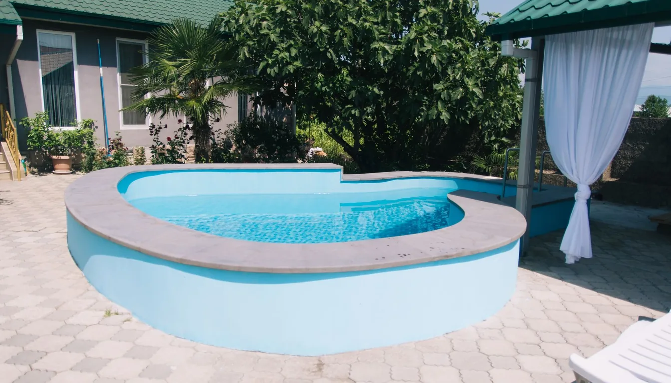 A backyard swimming pool beside a house