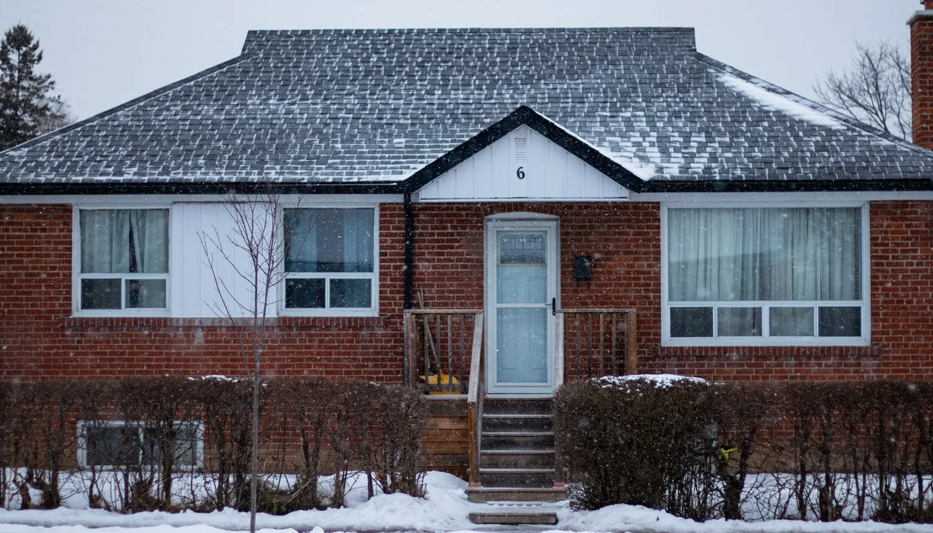 A suburban brick house under fresh snow